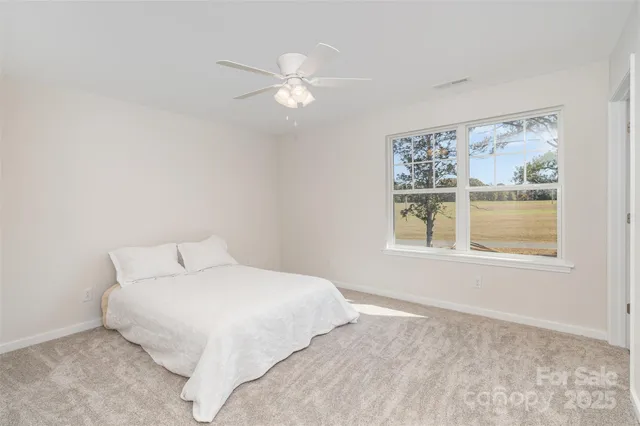 a bedroom with a large bed and a window
