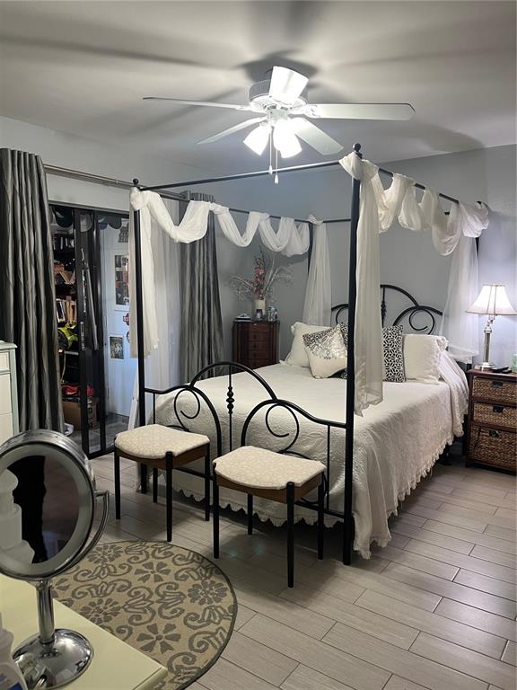 4154 66th St Circle West, Unit 4154 Bradenton, FL 34209 - Photo 12 of 28 a bedroom with a bed a mirror and lamp