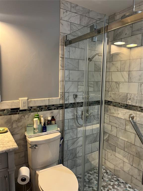 4154 66th St Circle West, Unit 4154 Bradenton, FL 34209 - Photo 13 of 28 a bathroom with a toilet and a shower