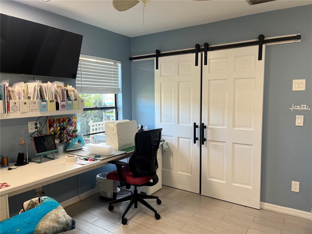 4154 66th St Circle West, Unit 4154 Bradenton, FL 34209 - Photo 16 of 28 a view of a workspace with furniture and a window