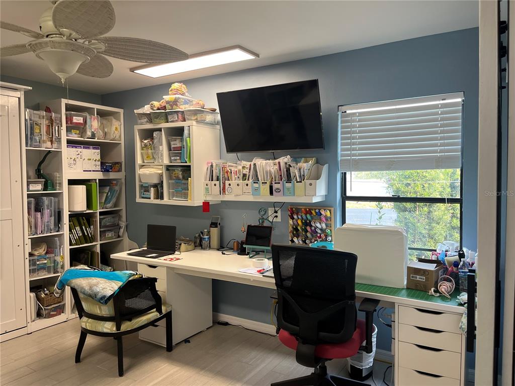 4154 66th St Circle West, Unit 4154 Bradenton, FL 34209 - Photo 17 of 28 a room with furniture and a flat screen tv