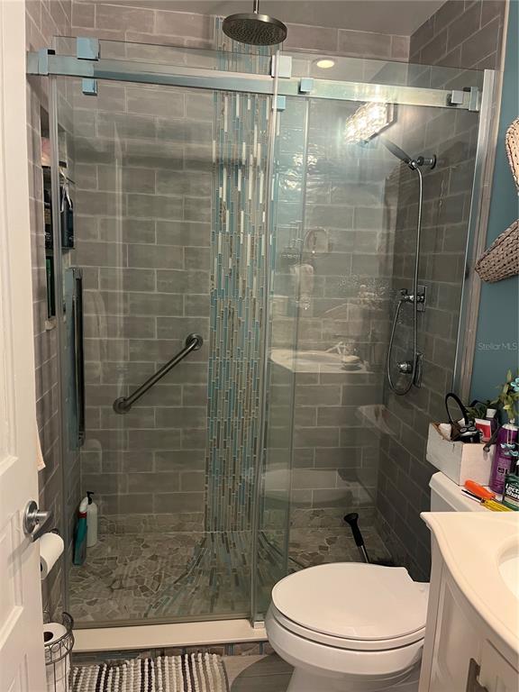 4154 66th St Circle West, Unit 4154 Bradenton, FL 34209 - Photo 18 of 28 a bathroom with a toilet and shower