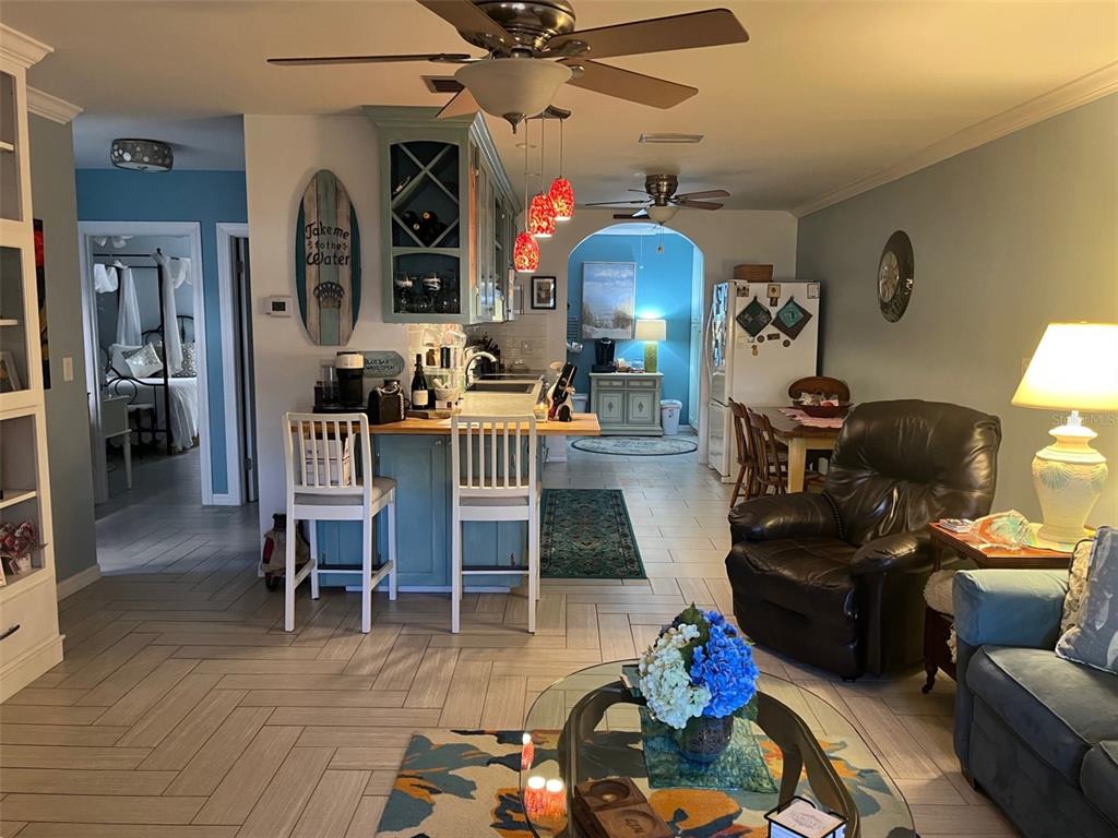 4154 66th St Circle West, Unit 4154 Bradenton, FL 34209 - Photo 2 of 28 a living room with furniture and wooden floor