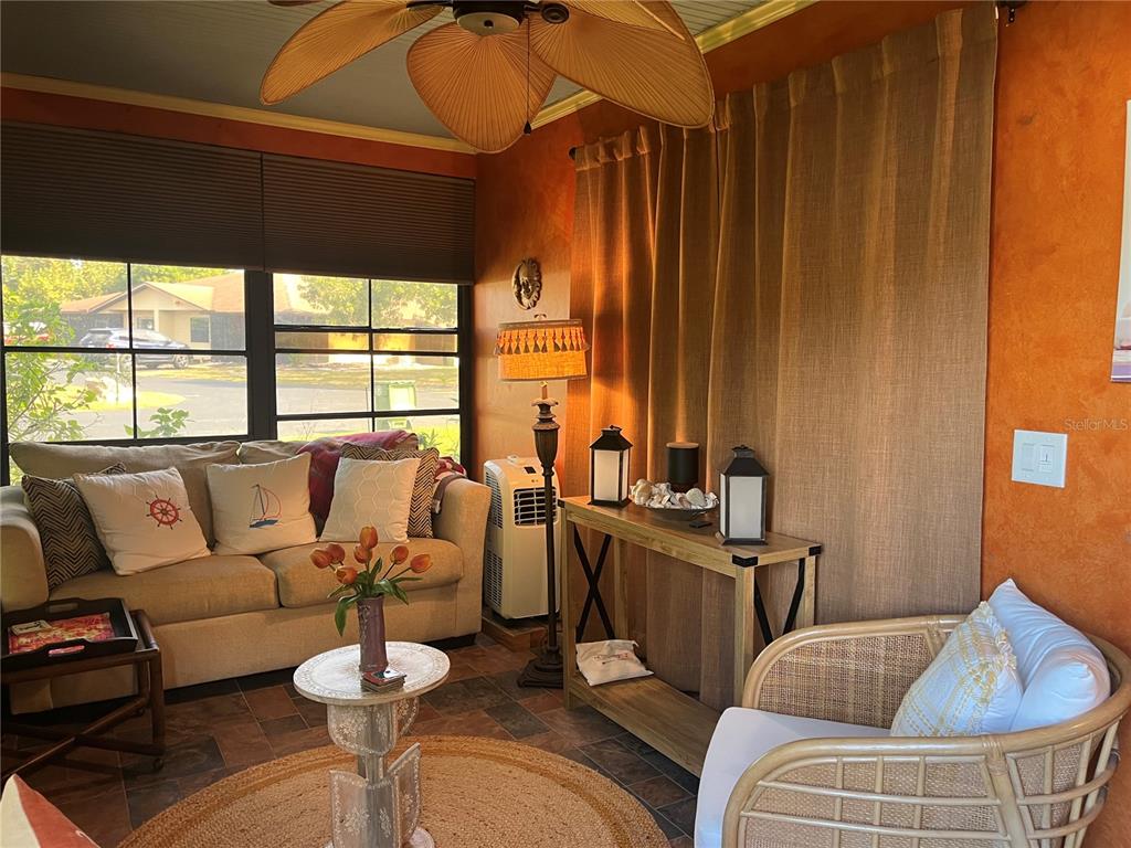 4154 66th St Circle West, Unit 4154 Bradenton, FL 34209 - Photo 23 of 28 a living room with furniture and a large window