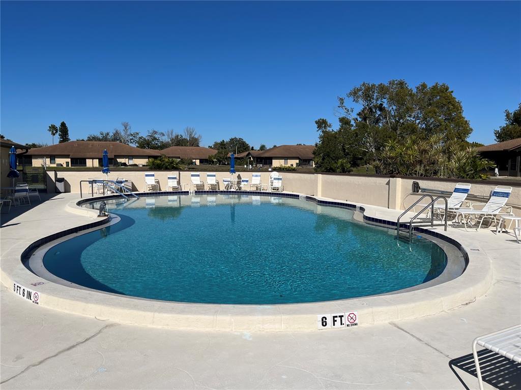 4154 66th St Circle West, Unit 4154 Bradenton, FL 34209 - Photo 25 of 28 a view of a swimming pool with a yard