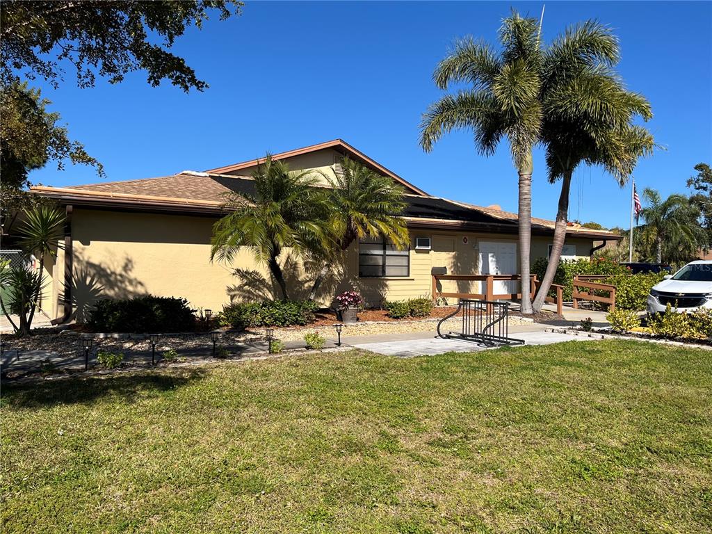 4154 66th St Circle West, Unit 4154 Bradenton, FL 34209 - Photo 28 of 28 a view of a house with backyard porch and sitting area