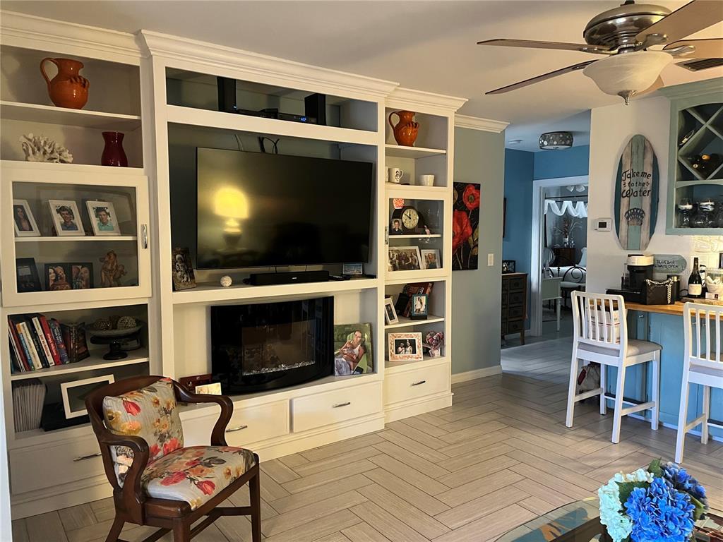 4154 66th St Circle West, Unit 4154 Bradenton, FL 34209 - Photo 3 of 28 a living room with furniture and a flat screen tv