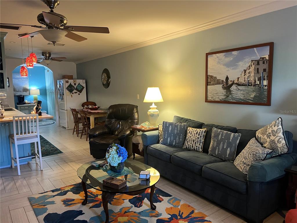4154 66th St Circle West, Unit 4154 Bradenton, FL 34209 - Photo 5 of 28 a living room with furniture fireplace and a chandelier