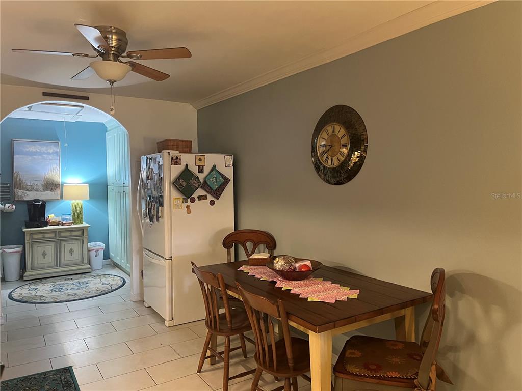 4154 66th St Circle West, Unit 4154 Bradenton, FL 34209 - Photo 6 of 28 a view of a dining room with furniture and a chandelier fan