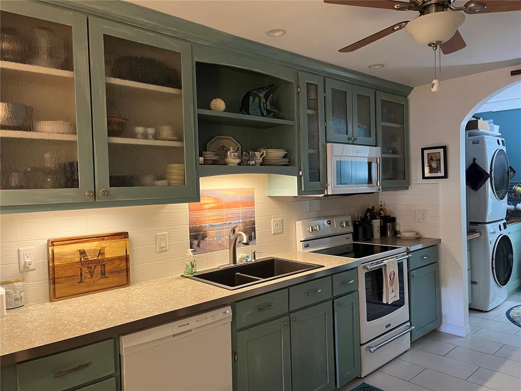 4154 66th St Circle West, Unit 4154 Bradenton, FL 34209 - Photo 7 of 28 a kitchen with stainless steel appliances a sink stove and cabinets