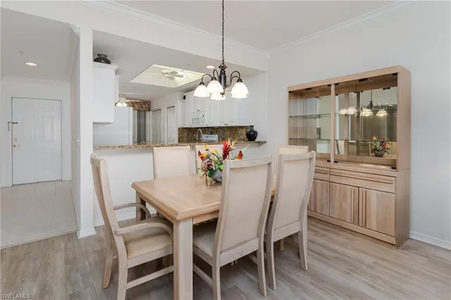 a view of a dining room with furniture wooden floor and chandelier