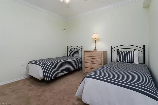 a bedroom with two beds and a baby crib