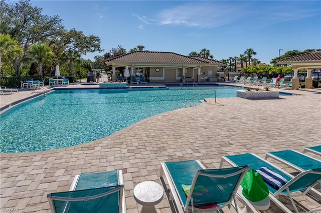 swimming pool view with a seating space