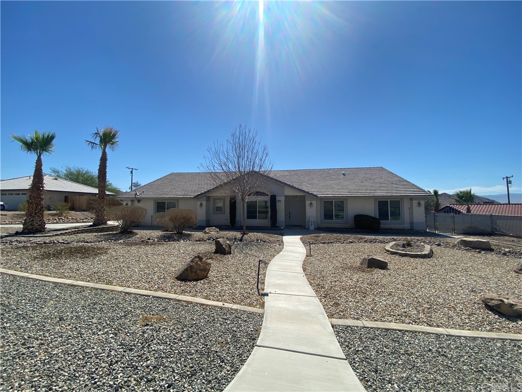 16707 Kasson Road Apple Valley, CA 92307 - Photo 1 of 1 a front view of a house with garden