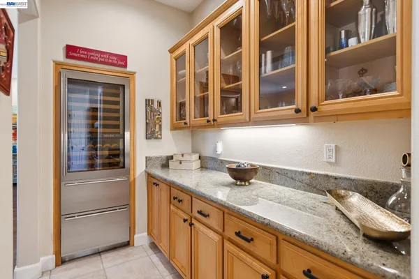 a bathroom with a granite countertop sink and a window
