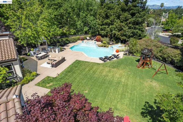 a view of backyard with table and chairs and potted plants