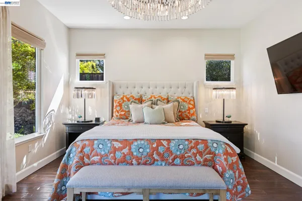 a bedroom with furniture and a large window