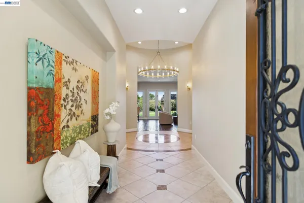 a view of a hallway with dining area and chandelier