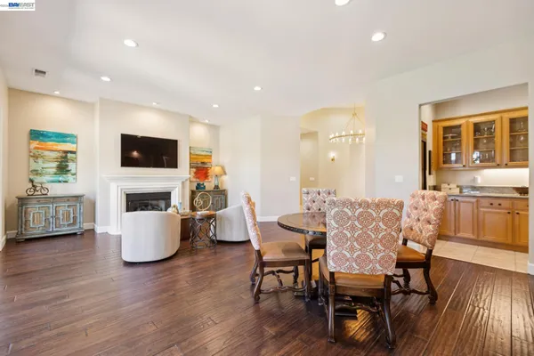 a dining room with furniture and a flat screen tv