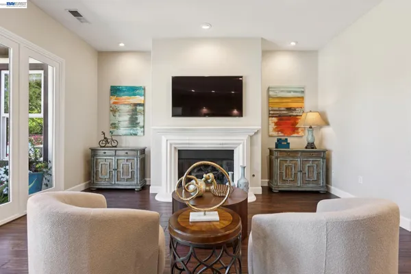 a living room with furniture a flat screen tv and a fireplace