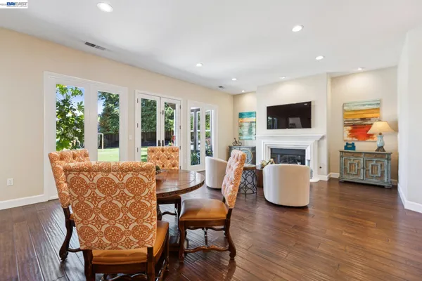 a dining room with furniture a window and a fireplace