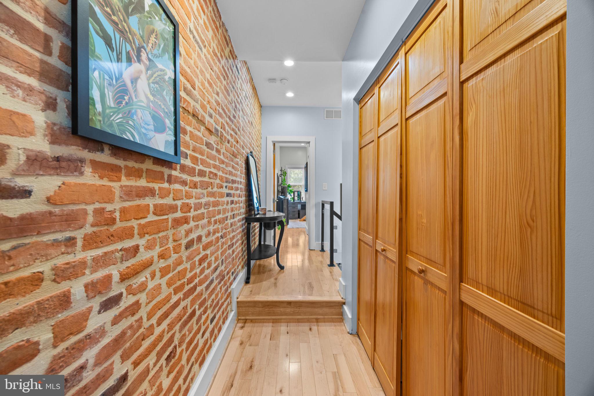 3208 Elliott Street Baltimore, MD 21224 - Photo 22 of 42 a view of a hallway with wooden floor and staircase