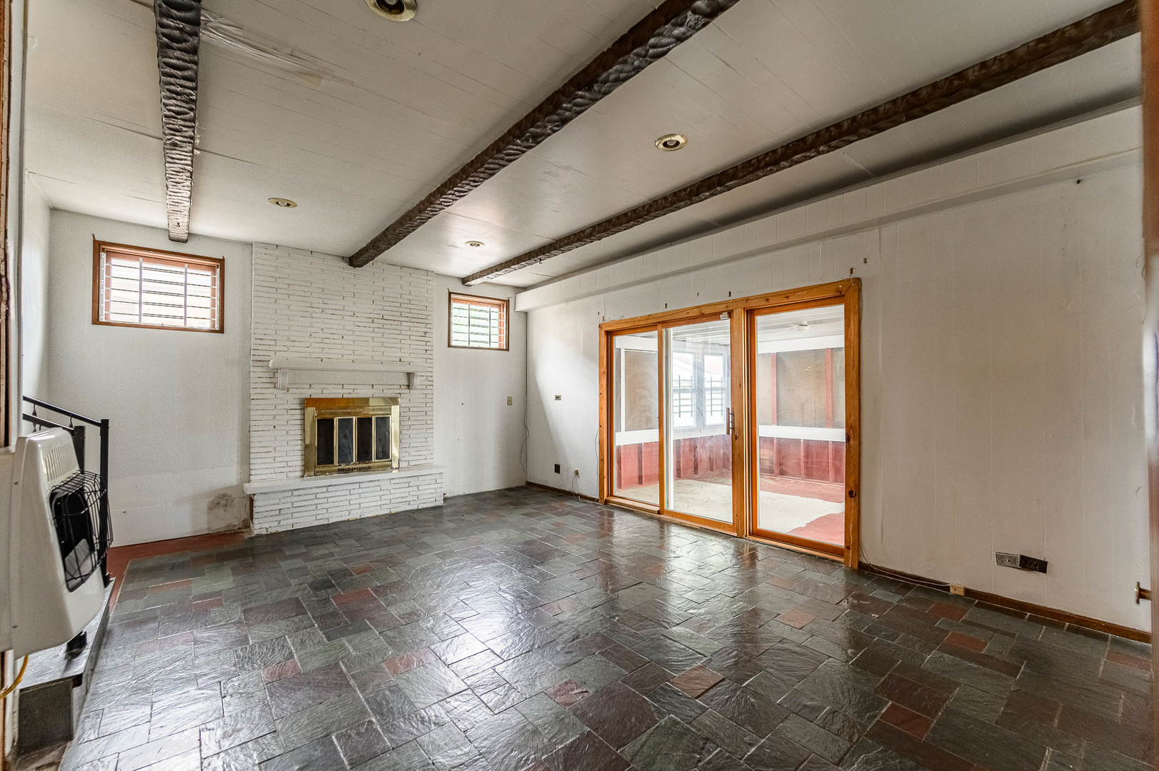 2834 West 85th Place Chicago, IL 60652 - Photo 11 of 17 a view of an empty room with a fireplace and a window
