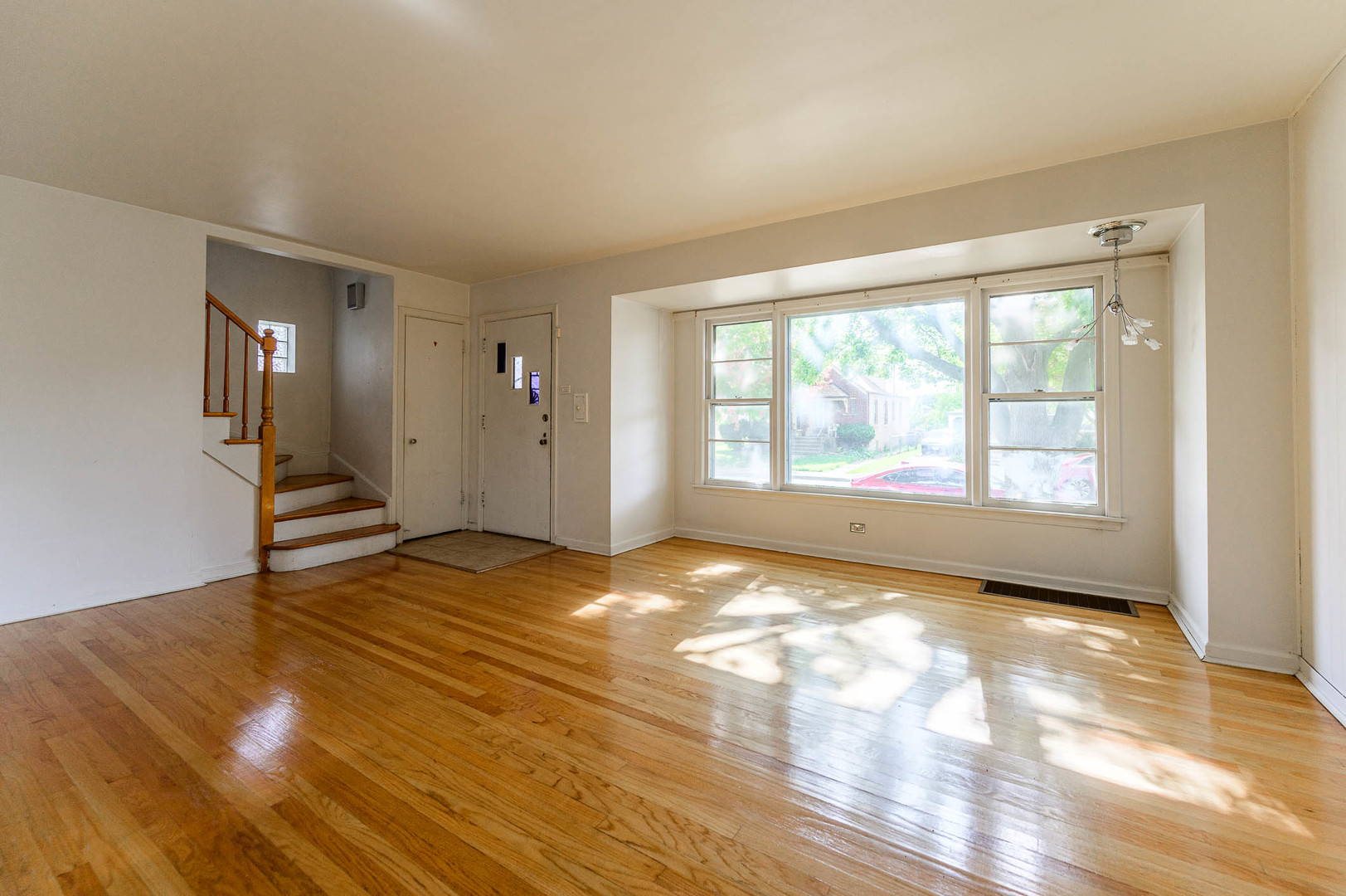 2834 West 85th Place Chicago, IL 60652 - Photo 2 of 17 a view of an empty room with wooden floor and a window