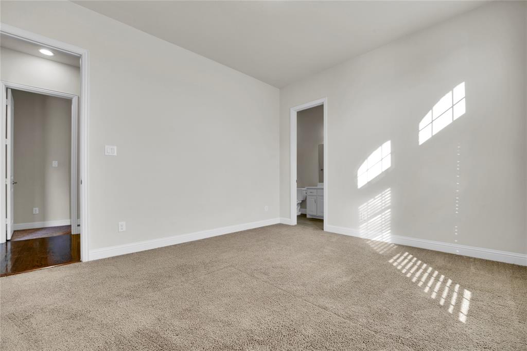 1011 Prairie Ridge Lane Arlington, TX 76005 - Photo 13 of 32 Carpeted room with neutral wall tones and white baseboards