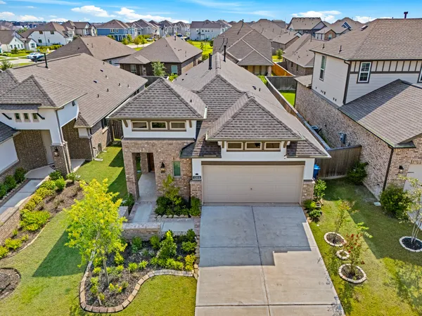 an aerial view of a house with a swimming pool