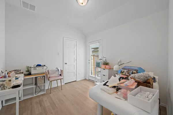 a view of a workspace with furniture and wooden floor
