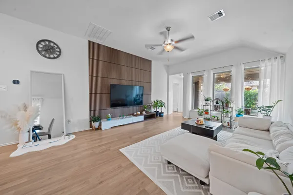 a living room with furniture fireplace and flat screen tv