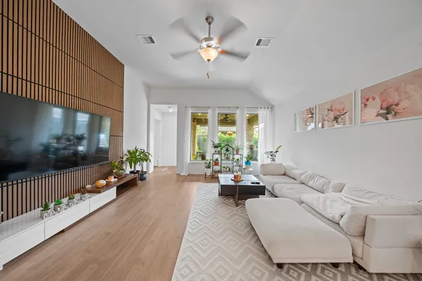 a living room with furniture and a chandelier
