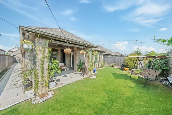 a front view of a house with a garden and plants