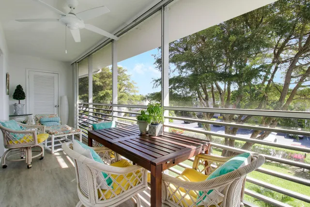 a view of a chairs and table in patio with wooden floor