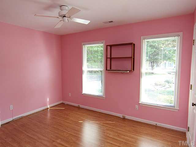 2611 Cottage Circle Raleigh, NC 27613 - Photo 11 of 15 a view of an empty room with a window and wooden floor