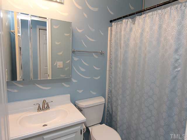 2611 Cottage Circle Raleigh, NC 27613 - Photo 12 of 15 a bathroom with a sink a toilet and shower