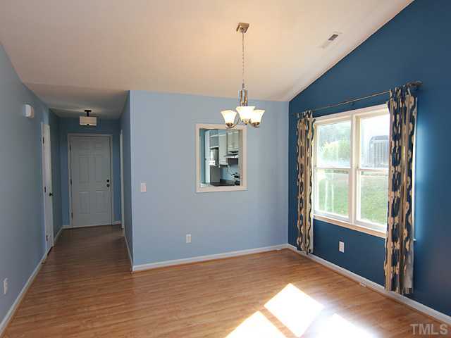 2611 Cottage Circle Raleigh, NC 27613 - Photo 4 of 15 a view of an empty room with window and hardwood floor