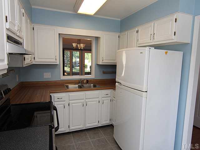 2611 Cottage Circle Raleigh, NC 27613 - Photo 7 of 15 a white refrigerator freezer sitting in a kitchen
