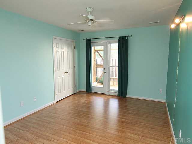 2611 Cottage Circle Raleigh, NC 27613 - Photo 9 of 15 a view of an empty room with window and wooden floor