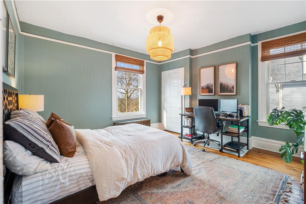 300 Maple Avenue Pittsburgh, PA 15218 - Photo 12 of 25 a bedroom with a bed a table and windows