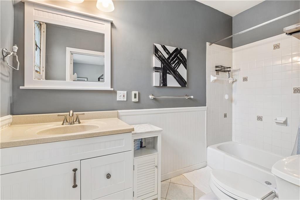 300 Maple Avenue Pittsburgh, PA 15218 - Photo 14 of 25 a bathroom with a sink a toilet and a mirror