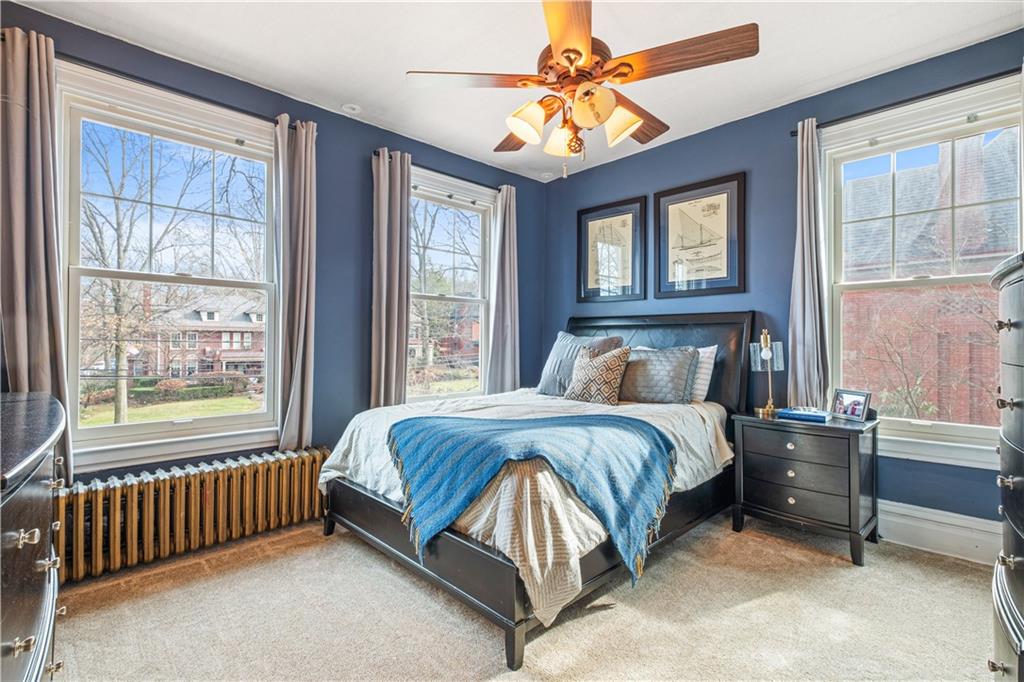 300 Maple Avenue Pittsburgh, PA 15218 - Photo 15 of 25 a spacious bedroom with a bed and a chandelier