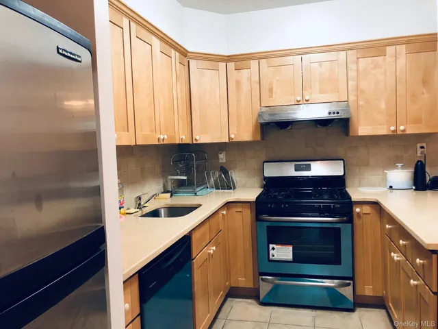 a kitchen with a sink stove top oven and cabinets