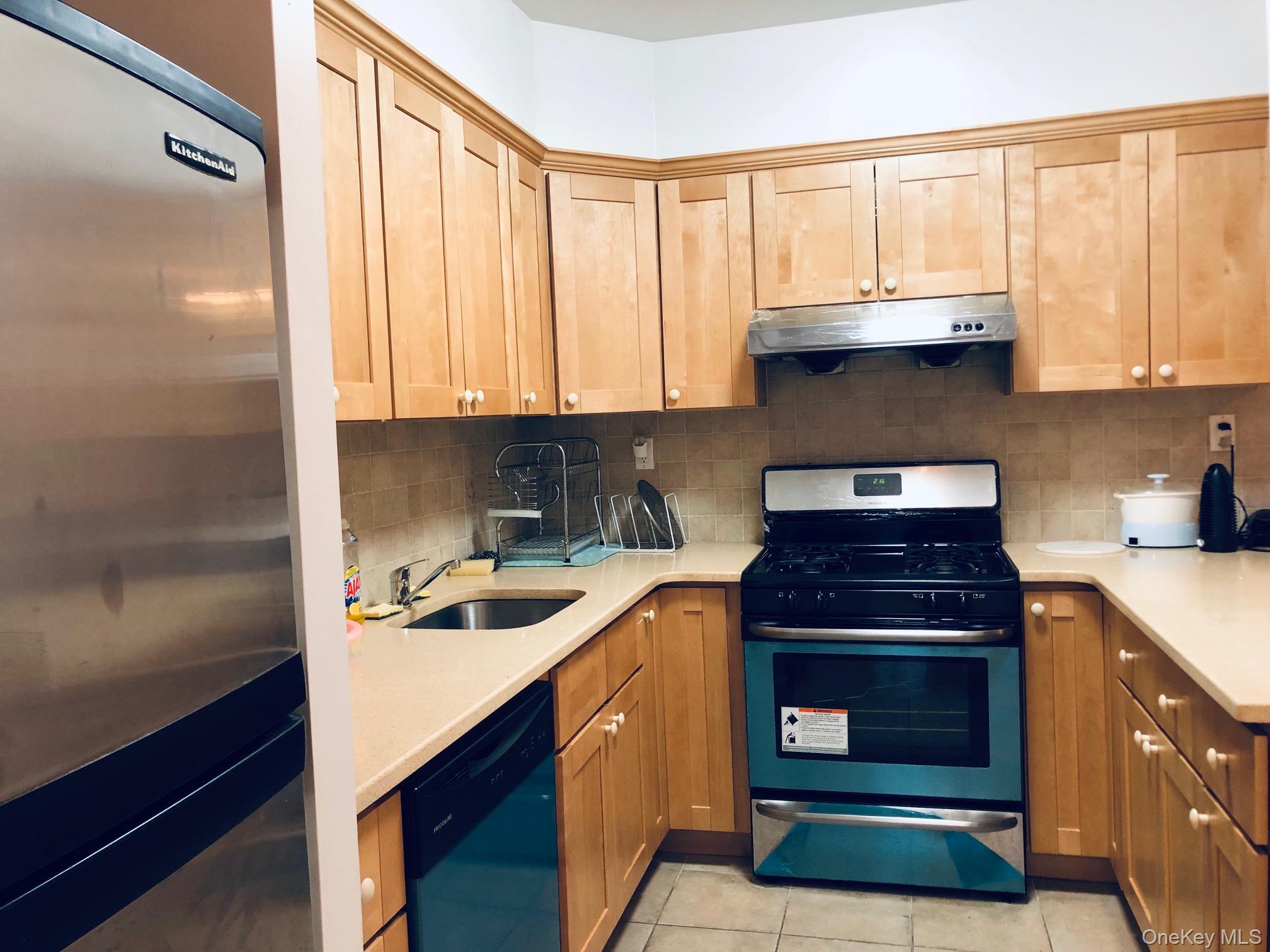 42-31 Colden Street, Unit F3E/3G Queens, NY 11355 - Photo 3 of 9 a kitchen with a sink stove top oven and cabinets