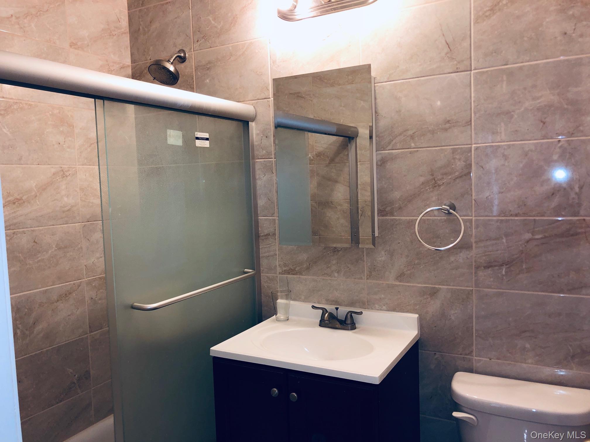 42-31 Colden Street, Unit F3E/3G Queens, NY 11355 - Photo 6 of 9 a bathroom with a sink toilet and shower