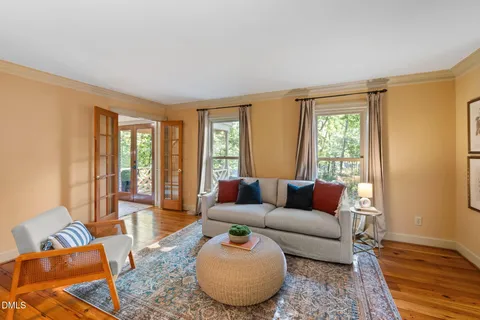 a living room with furniture and a chandelier