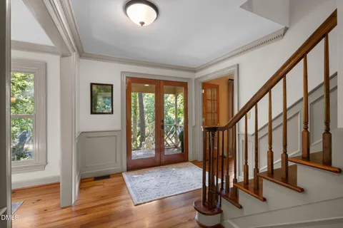 a view of an entryway with wooden floor and door