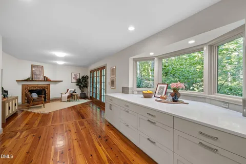 a dining room with furniture window and wooden floor