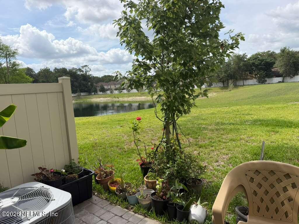 11865 Junegrass Road Jacksonville, FL 32258 - Photo 17 of 17 a front view of a house with a garden and lake view